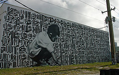 This Miami mural was created from a Photo that El Mac took in Phoenix. “What I really liked about that is that at one point we were all kids. He’s holding a piece of chalk so I looked at him as a young scribe."