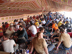 After a day of riding, racers rest in the carpet tents sent up in the bivouac.
