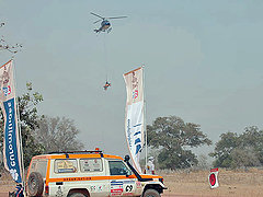 A helicopter hauls away a dead motorcycle.
